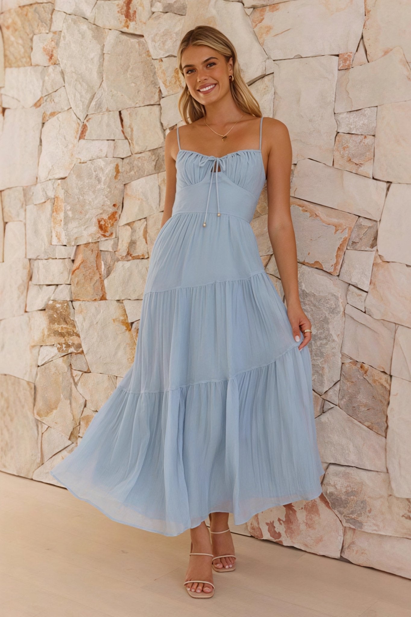 Maxi dress with spaghetti straps, open back, and flared skirt